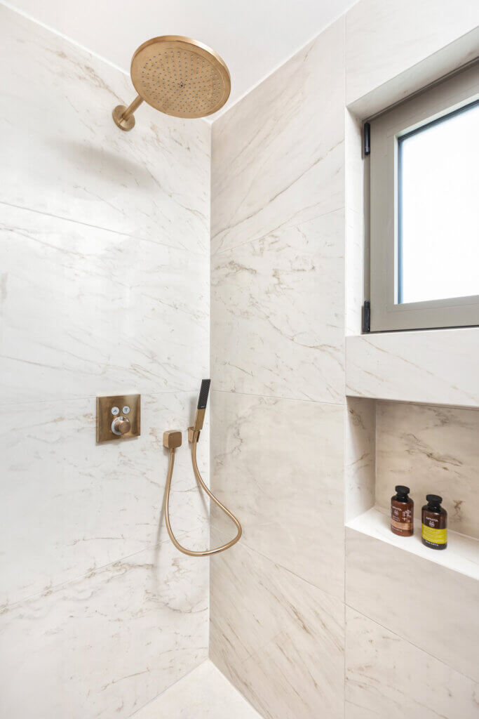 Marble finish walk-in shower.