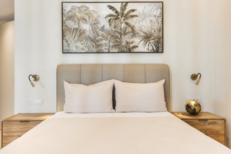 The neutral palette is elevated by tasteful artwork above the headboard, bringing a sense of the island’s natural beauty indoors. Sleek bedside fixtures offer a warm glow, perfect for unwinding with a good book.